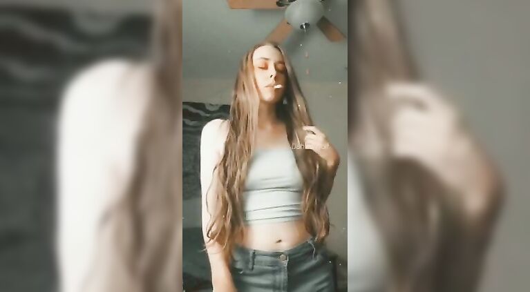 Smoking in Jeans and a Tank Top